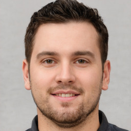 Joyful white young-adult male with short  brown hair and brown eyes