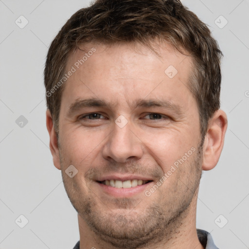 Joyful white adult male with short  brown hair and brown eyes