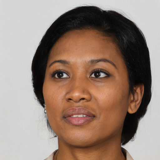 Joyful black adult female with medium  black hair and brown eyes