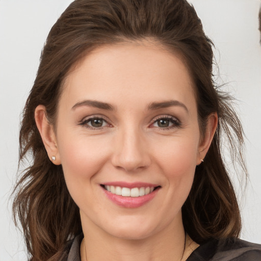 Joyful white young-adult female with long  brown hair and brown eyes