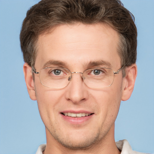 Joyful white adult male with short  brown hair and grey eyes