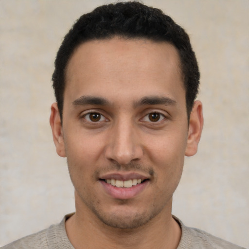 Joyful white young-adult male with short  black hair and brown eyes