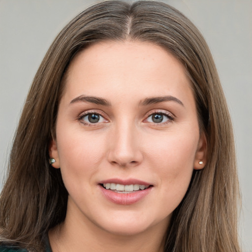 Joyful white young-adult female with long  brown hair and green eyes