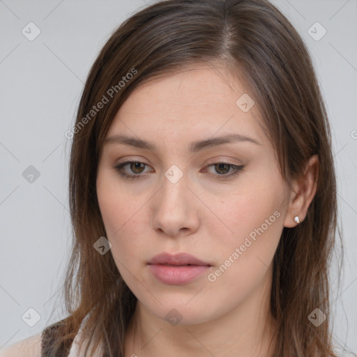 Neutral white young-adult female with long  brown hair and brown eyes