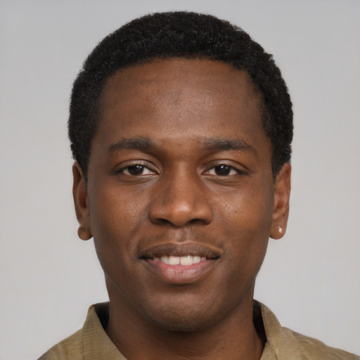 Joyful black young-adult male with short  black hair and brown eyes