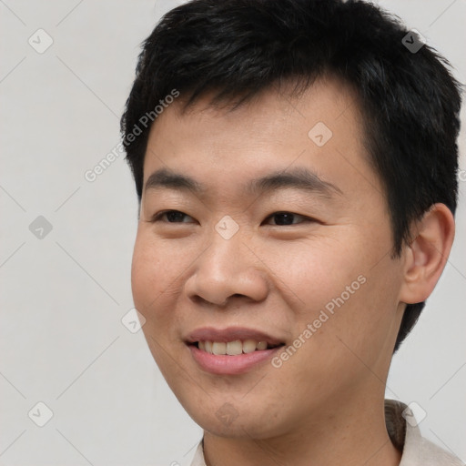 Joyful asian young-adult male with short  black hair and brown eyes