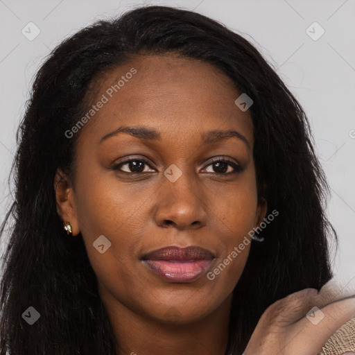 Joyful black young-adult female with long  brown hair and brown eyes