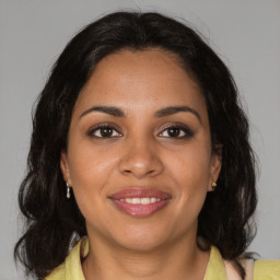 Joyful black young-adult female with medium  brown hair and brown eyes