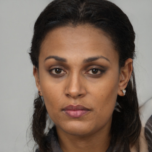 Neutral black young-adult female with long  brown hair and brown eyes