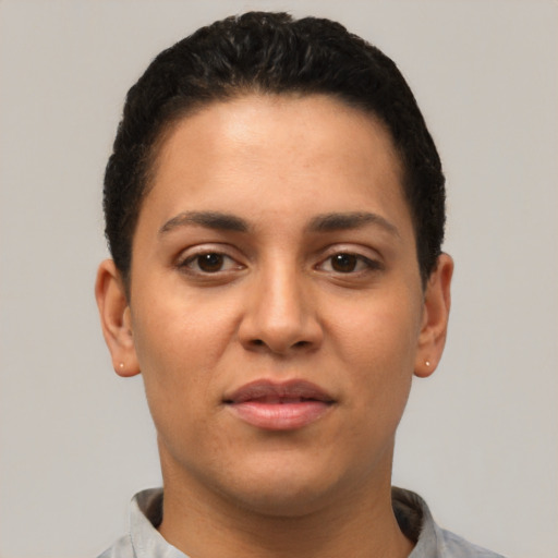 Joyful latino young-adult female with short  black hair and brown eyes