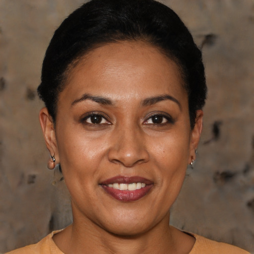 Joyful latino adult female with short  black hair and brown eyes