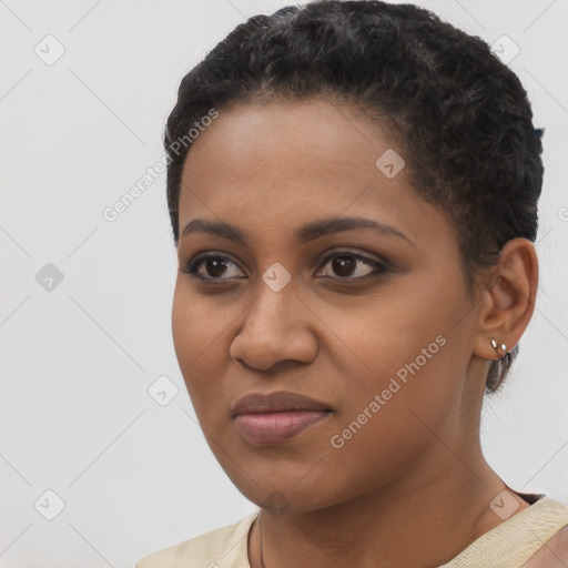 Joyful black young-adult female with short  black hair and brown eyes