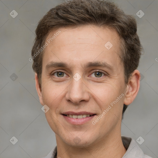 Joyful white adult male with short  brown hair and grey eyes