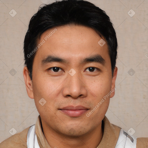 Joyful asian young-adult male with short  black hair and brown eyes