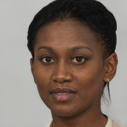 Joyful black young-adult female with short  black hair and brown eyes