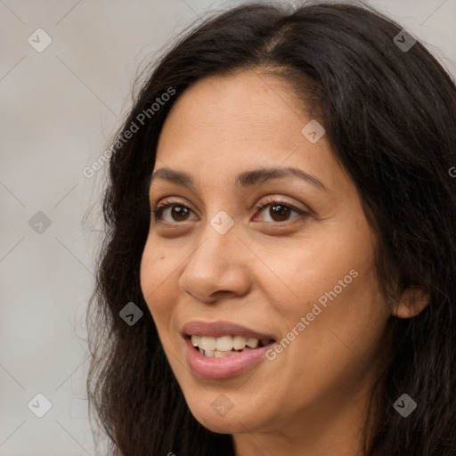 Joyful white adult female with long  brown hair and brown eyes