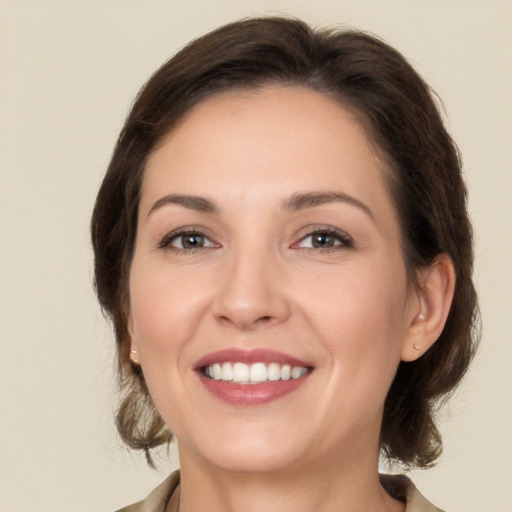 Joyful white young-adult female with medium  brown hair and brown eyes