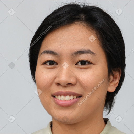 Joyful asian young-adult female with medium  black hair and brown eyes