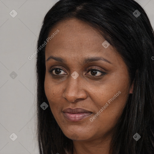 Joyful black adult female with long  brown hair and brown eyes