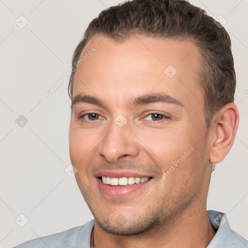 Joyful white young-adult male with short  brown hair and brown eyes