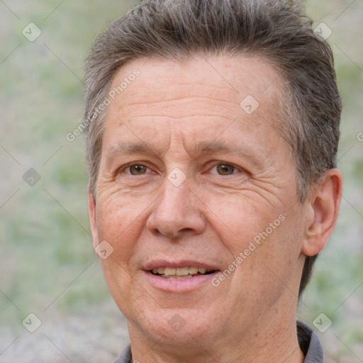 Joyful white middle-aged male with short  brown hair and brown eyes