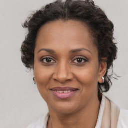 Joyful black adult female with medium  brown hair and brown eyes