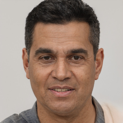 Joyful white adult male with short  black hair and brown eyes