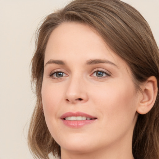 Joyful white young-adult female with long  brown hair and green eyes