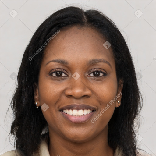 Joyful black young-adult female with long  brown hair and brown eyes