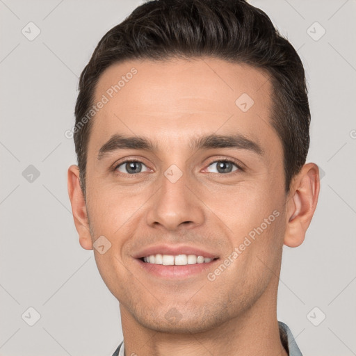 Joyful white young-adult male with short  brown hair and brown eyes