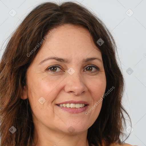 Joyful white adult female with long  brown hair and brown eyes