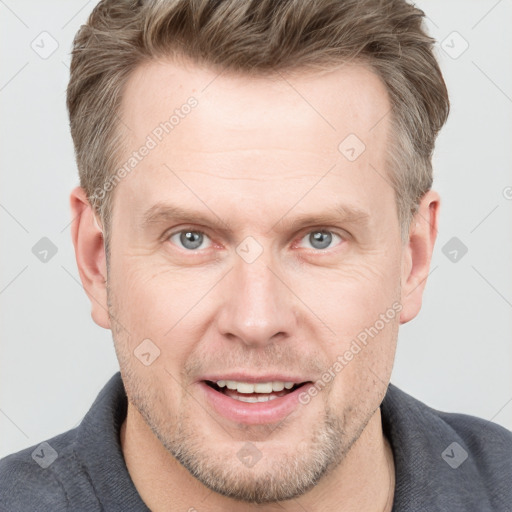 Joyful white adult male with short  brown hair and grey eyes