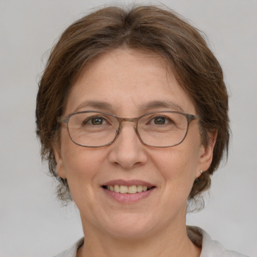 Joyful white adult female with medium  brown hair and grey eyes