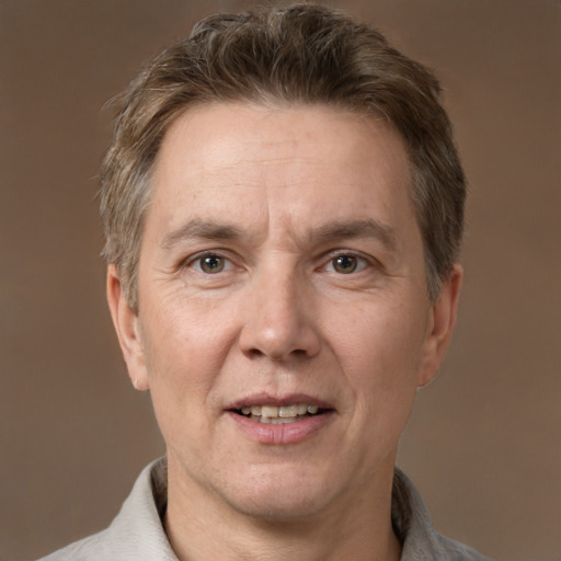 Joyful white adult male with short  brown hair and grey eyes