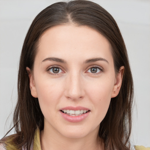 Joyful white young-adult female with long  brown hair and brown eyes