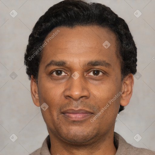 Joyful latino adult male with short  black hair and brown eyes