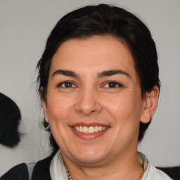 Joyful white adult female with medium  brown hair and brown eyes