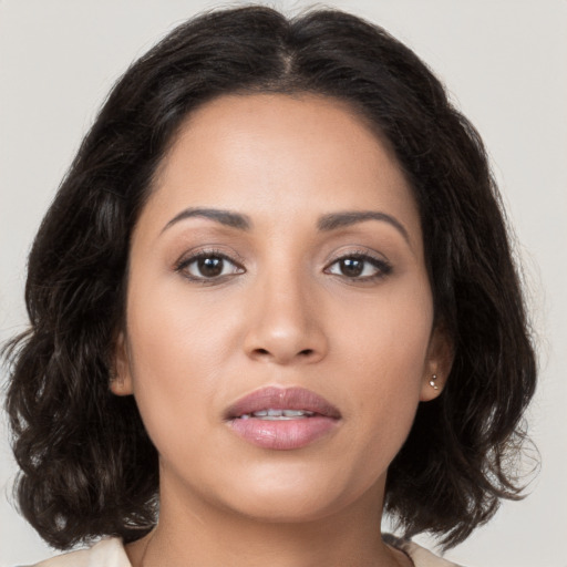 Joyful white young-adult female with medium  brown hair and brown eyes