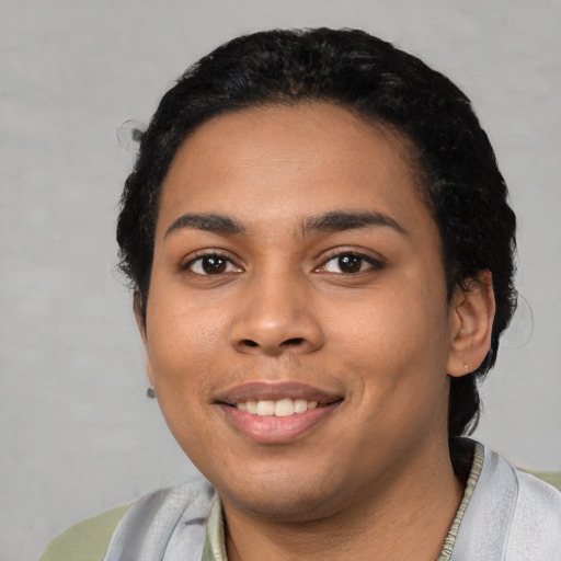 Joyful latino young-adult female with short  black hair and brown eyes