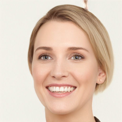 Joyful white young-adult female with medium  brown hair and green eyes