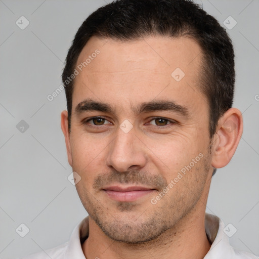 Joyful white young-adult male with short  brown hair and brown eyes