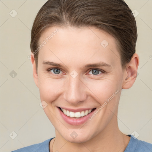 Joyful white young-adult female with short  brown hair and grey eyes