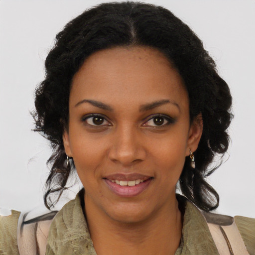 Joyful black young-adult female with long  brown hair and brown eyes