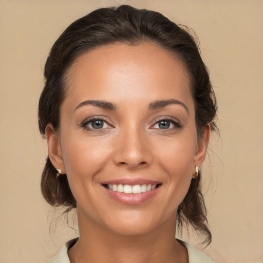 Joyful white young-adult female with medium  brown hair and brown eyes