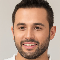 Joyful white young-adult male with short  brown hair and brown eyes