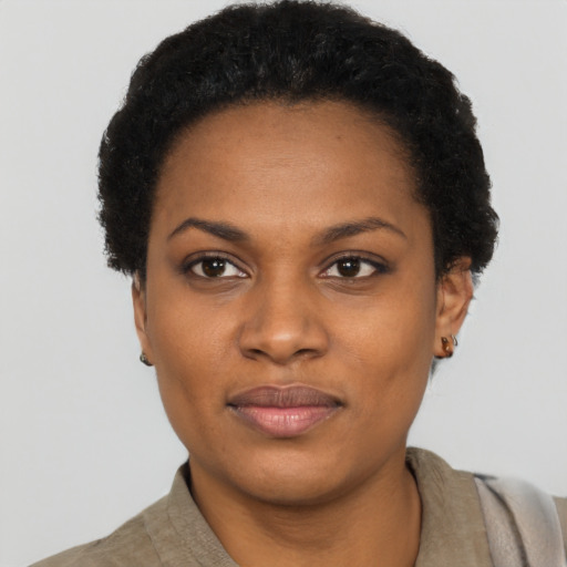 Joyful black young-adult female with short  black hair and brown eyes