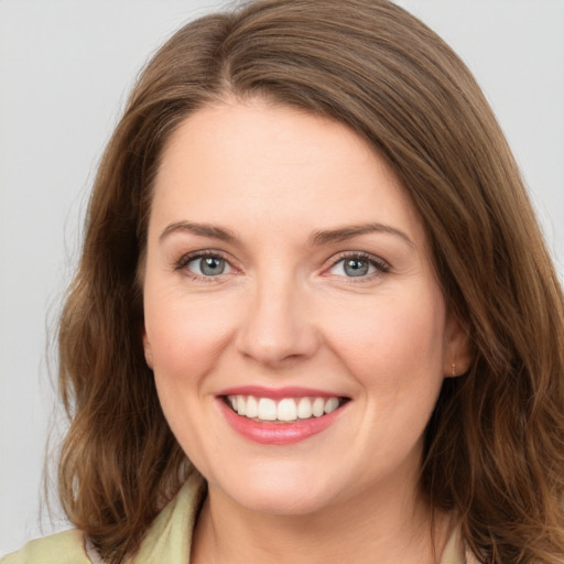 Joyful white young-adult female with medium  brown hair and green eyes