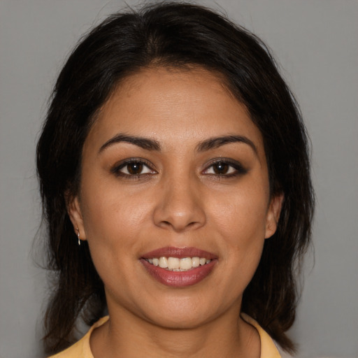 Joyful white young-adult female with medium  brown hair and brown eyes