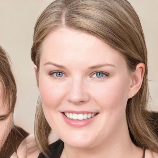 Joyful white young-adult female with medium  brown hair and blue eyes