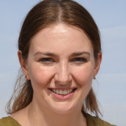 Joyful white adult female with medium  brown hair and brown eyes